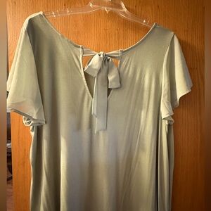 Pale green woman’s blouse with bow
